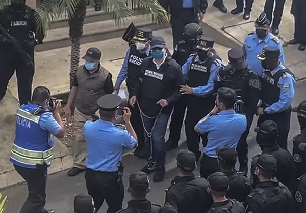 [사진=경찰에 체포되는 에르난데스 전 온두라스 대통령(가운데), 온두라스 경찰 제공/AFP/연합뉴스]